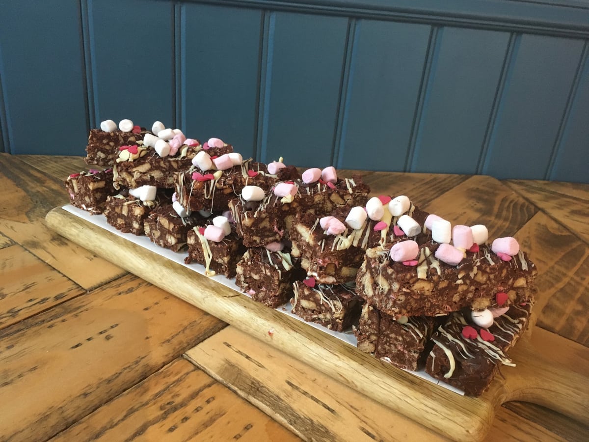Chocolate traybakes on the café's wooden counter